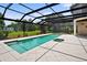 Screened-in pool features a spa and views of the well-maintained lawn at 10352 Burris Ct, Orlando, FL 32836