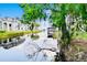 Scenic waterfront view of a modern home with a private boat dock on a tranquil lake at 10352 Burris Ct, Orlando, FL 32836
