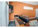 This wet bar has tile flooring, wooden cabinets and countertop, and a built-in television at 10352 Burris Ct, Orlando, FL 32836