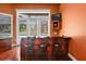 Wet bar featuring dark cabinetry, a granite countertop, and seating for three at 10352 Burris Ct, Orlando, FL 32836
