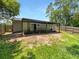 Backyard featuring a covered patio, partial lawn, and wood fence at 14837 Sussex Dr, Orlando, FL 32826