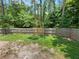 Large, private backyard featuring a wood fence and mature trees, perfect for outdoor activities at 14837 Sussex Dr, Orlando, FL 32826