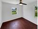 Bright bedroom featuring a ceiling fan and ample natural light from two windows at 14837 Sussex Dr, Orlando, FL 32826