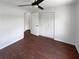 Neutral bedroom with ceiling fan, large closet, and wood floor at 14837 Sussex Dr, Orlando, FL 32826