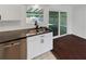 Close up of modern kitchen featuring updated faucet, stainless steel dishwasher, and granite countertop at 14837 Sussex Dr, Orlando, FL 32826