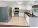Well-lit kitchen featuring stainless steel appliances, granite countertops, and white cabinets at 14837 Sussex Dr, Orlando, FL 32826