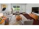 Bright living room with plush seating, large window, and stylish decor for a comfortable and inviting atmosphere at 14837 Sussex Dr, Orlando, FL 32826