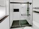 Modern shower with black trim, black fixtures, and hexagonal floor tiling at 14837 Sussex Dr, Orlando, FL 32826