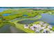 Beautiful aerial view of a modern home surrounded by lush green landscapes and serene lakes at 15208 Lake Claire Overlook Dr, Winter Garden, FL 34787
