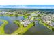 Gorgeous aerial view of lakefront homes in a suburban neighborhood with lush greenery at 15208 Lake Claire Overlook Dr, Winter Garden, FL 34787