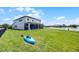 A lovely home with a sprawling lawn, screened porch, and lake view, complete with a kayak for adventures at 15208 Lake Claire Overlook Dr, Winter Garden, FL 34787