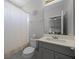Bathroom with a shower, stylish vanity, and a large mirror at 15208 Lake Claire Overlook Dr, Winter Garden, FL 34787