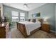 Cozy bedroom with natural light, a plush rug, and nature-inspired decor for a relaxing retreat at 15208 Lake Claire Overlook Dr, Winter Garden, FL 34787