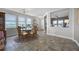 Bright dining room featuring stone table, wood chairs, tile floors, and natural light at 15208 Lake Claire Overlook Dr, Winter Garden, FL 34787