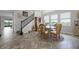 Well lit dining room featuring stone table, wood chairs, and luxury tile floors at 15208 Lake Claire Overlook Dr, Winter Garden, FL 34787