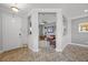Elegant foyer with tile flooring, decorative archways, and a view into the living room at 15208 Lake Claire Overlook Dr, Winter Garden, FL 34787