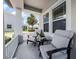 Inviting front porch with comfortable seating, stylish decor, and picturesque views of the neighborhood at 15208 Lake Claire Overlook Dr, Winter Garden, FL 34787