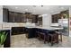 Modern kitchen with dark cabinetry, an island with seating, stainless steel appliances, and white subway tile backsplash at 15208 Lake Claire Overlook Dr, Winter Garden, FL 34787
