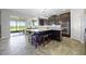 Modern kitchen with an island featuring bar seating and stainless steel appliances at 15208 Lake Claire Overlook Dr, Winter Garden, FL 34787