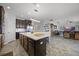 Modern kitchen featuring an island and stainless steel appliances seamlessly connected to a cozy living area at 15208 Lake Claire Overlook Dr, Winter Garden, FL 34787