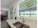 Modern kitchen features quartz countertop and view of the backyard at 15208 Lake Claire Overlook Dr, Winter Garden, FL 34787