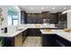 Modern kitchen with stainless steel appliances, white countertops and dark cabinetry at 15208 Lake Claire Overlook Dr, Winter Garden, FL 34787