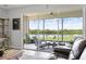 Relaxing lanai with comfortable seating and stunning views of the lake and lush landscaping at 15208 Lake Claire Overlook Dr, Winter Garden, FL 34787