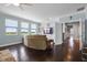 This living room boasts large windows, a neutral sofa, and a sleek entertainment center at 15208 Lake Claire Overlook Dr, Winter Garden, FL 34787