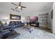 Spacious living room with a fireplace, mounted tv, and leather reclining sofa at 15208 Lake Claire Overlook Dr, Winter Garden, FL 34787