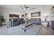 Comfortable living room with dual reclining sofas and a view into the kitchen at 15208 Lake Claire Overlook Dr, Winter Garden, FL 34787