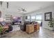 Bright living room with tile flooring, a ceiling fan, modern decor, and sliding glass doors offering lake views at 15208 Lake Claire Overlook Dr, Winter Garden, FL 34787