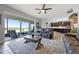Open-concept living room with leather sofas and views of the outdoor patio at 15208 Lake Claire Overlook Dr, Winter Garden, FL 34787