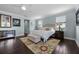 Bright main bedroom features a ceiling fan, rug, and decorative artwork and furniture at 15208 Lake Claire Overlook Dr, Winter Garden, FL 34787