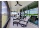 Inviting screened patio featuring lounge chairs and lake views at 15208 Lake Claire Overlook Dr, Winter Garden, FL 34787