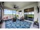 Inviting screened-in patio with comfortable seating, ceiling fan, and serene views of the lush backyard and lake at 15208 Lake Claire Overlook Dr, Winter Garden, FL 34787