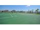 Well-maintained tennis courts with community homes in the background at 15208 Lake Claire Overlook Dr, Winter Garden, FL 34787
