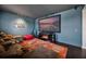 Home theater with a large screen, comfortable seating, and a cozy fireplace for entertainment at 15208 Lake Claire Overlook Dr, Winter Garden, FL 34787