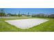 Sand volleyball court surrounded by green grass and community homes at 15208 Lake Claire Overlook Dr, Winter Garden, FL 34787