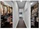 A glimpse of a hallway between two walk-in closets at 15208 Lake Claire Overlook Dr, Winter Garden, FL 34787