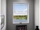 Window offers scenic views of a serene lake and lush greenery in a naturally lit space at 15208 Lake Claire Overlook Dr, Winter Garden, FL 34787