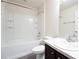 Bright bathroom featuring a shower-tub combo with white tile and a vanity with a dark wood finish at 15476 Sw 34Th Court Rd, Ocala, FL 34473