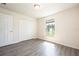Comfortable bedroom with laminate floors, closet, and bright window; a serene space at 15476 Sw 34Th Court Rd, Ocala, FL 34473