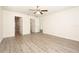 Spacious bedroom with multiple doorways, light walls, ceiling fan, and laminate wood flooring at 15476 Sw 34Th Court Rd, Ocala, FL 34473
