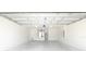 Spacious two car garage showcasing ample room, water heater and lighting at 15476 Sw 34Th Court Rd, Ocala, FL 34473