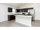 Modern kitchen featuring dark cabinets, stainless steel appliances, and a center island at 15476 Sw 34Th Court Rd, Ocala, FL 34473