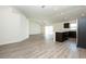 Open-concept living area and kitchen with modern stainless appliances and dark cabinets at 15476 Sw 34Th Court Rd, Ocala, FL 34473