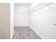 Spacious walk-in closet with laminate wood flooring and wire shelving for optimal storage at 15476 Sw 34Th Court Rd, Ocala, FL 34473