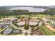 Panoramic aerial view of a community featuring tennis courts, a pool, and well-maintained landscaping at 15947 Vetta Dr, Bella Collina, FL 34756