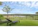 Enjoy the scenic backyard view with lounge chairs overlooking a serene lake and picturesque golf course at 15947 Vetta Dr, Bella Collina, FL 34756