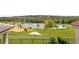 Backyard view with golf course, landscaping, pond, and covered patio at 15947 Vetta Dr, Bella Collina, FL 34756